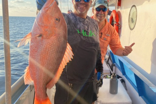 a man holding a fish