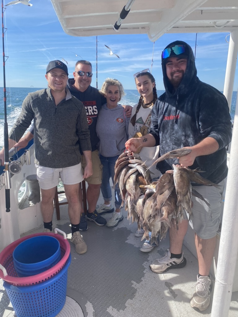 160B02C1-4DA3-4BDD-8176-C8381D45B864_1_105_c Coleen Prenda et al. standing next to a man holding a fish