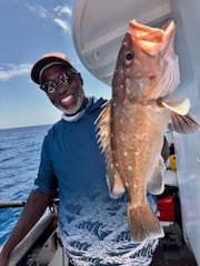a man holding a fish in the water