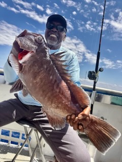 a man holding a fish