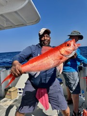 a person holding a fish