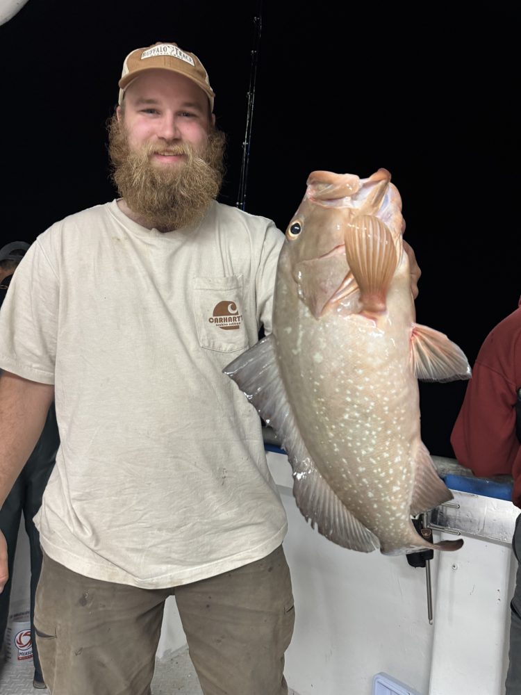 a man holding a fish