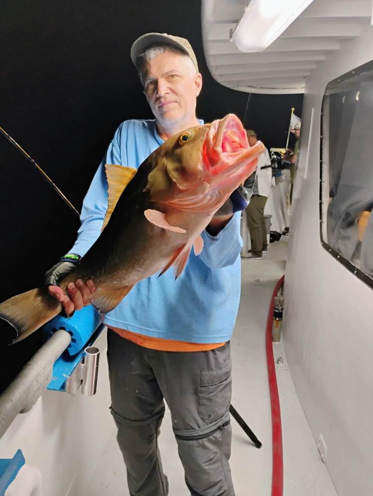a man holding a fish